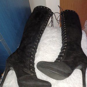 High heeled suede laceup boots with 4" heels.